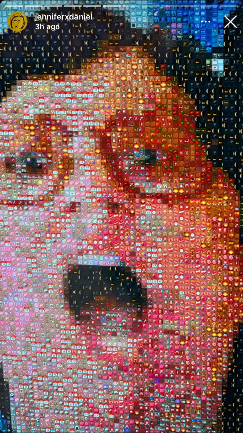 A visitor's face at arm's length in the mirror, mouth open, rebuilt entirely out of emoji